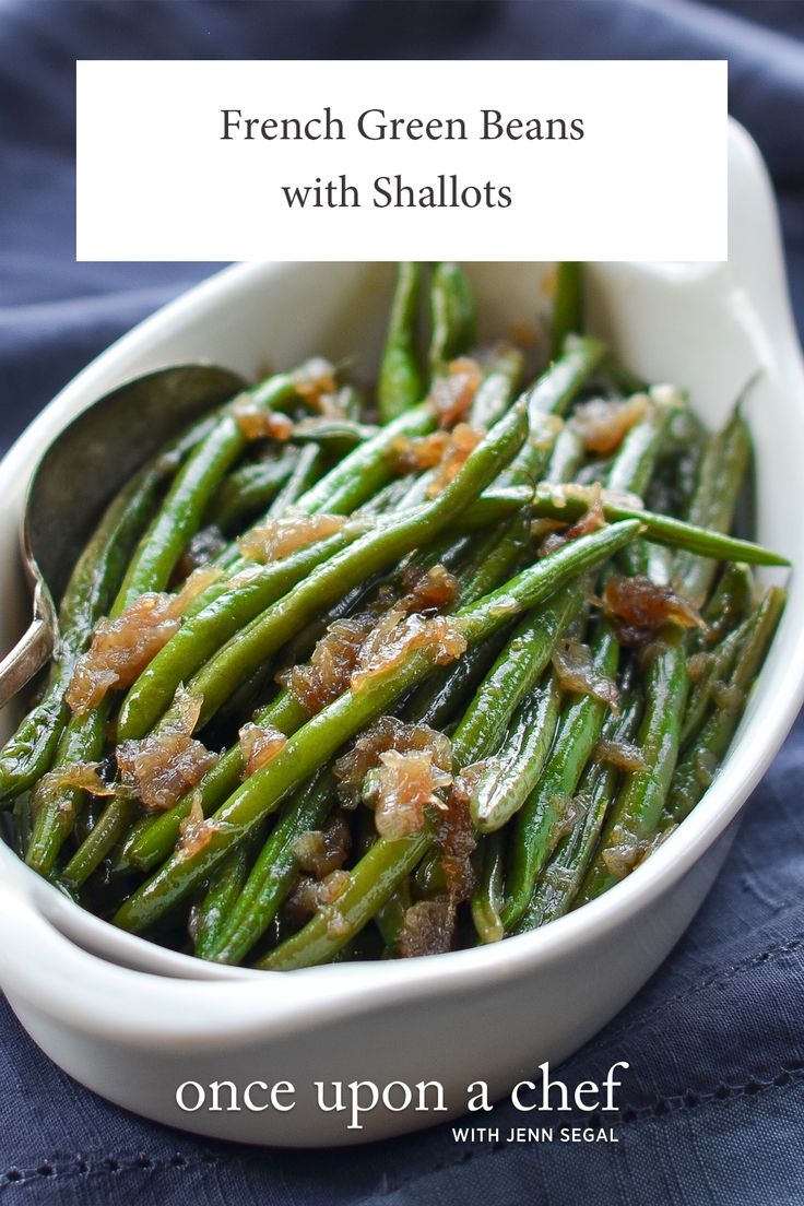 french green beans with shallots in a white dish on a blue tablecloth and text overlay