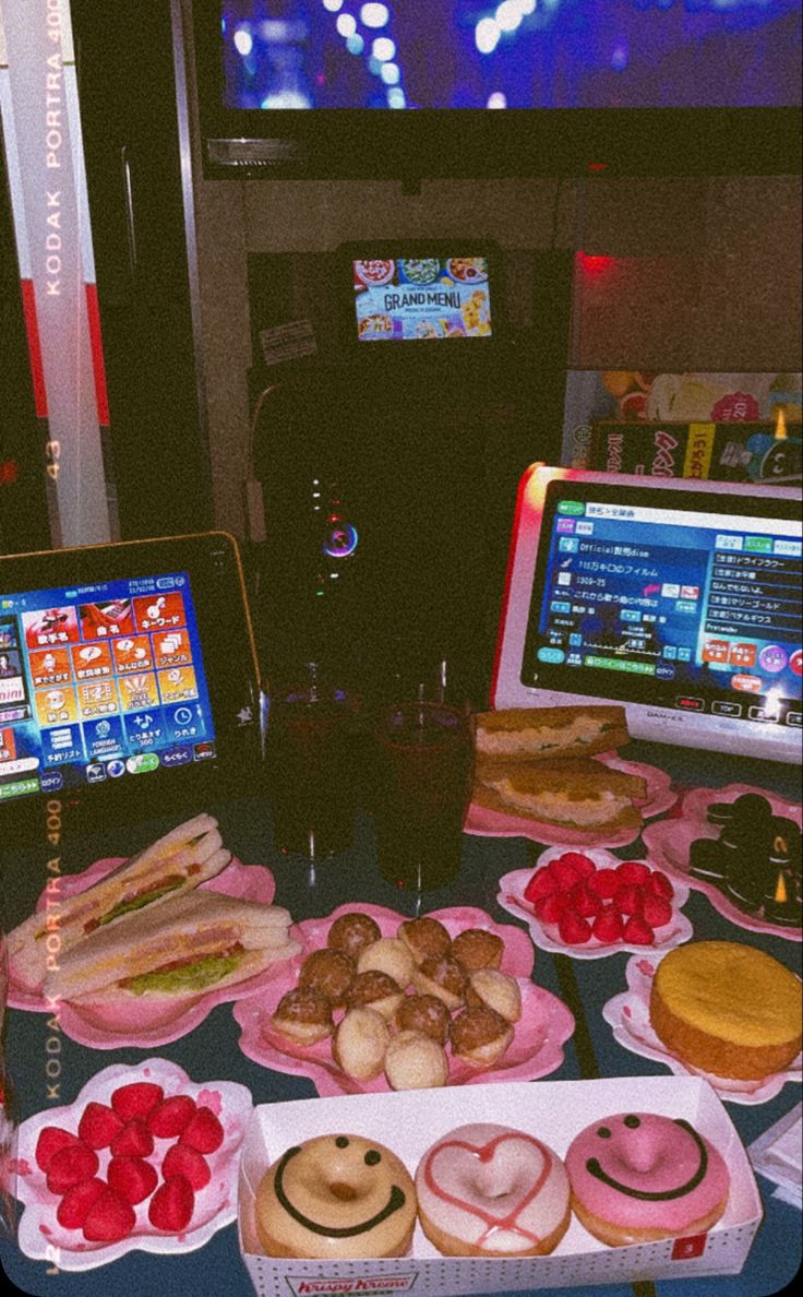 a table topped with lots of different types of donuts and other foods on plates