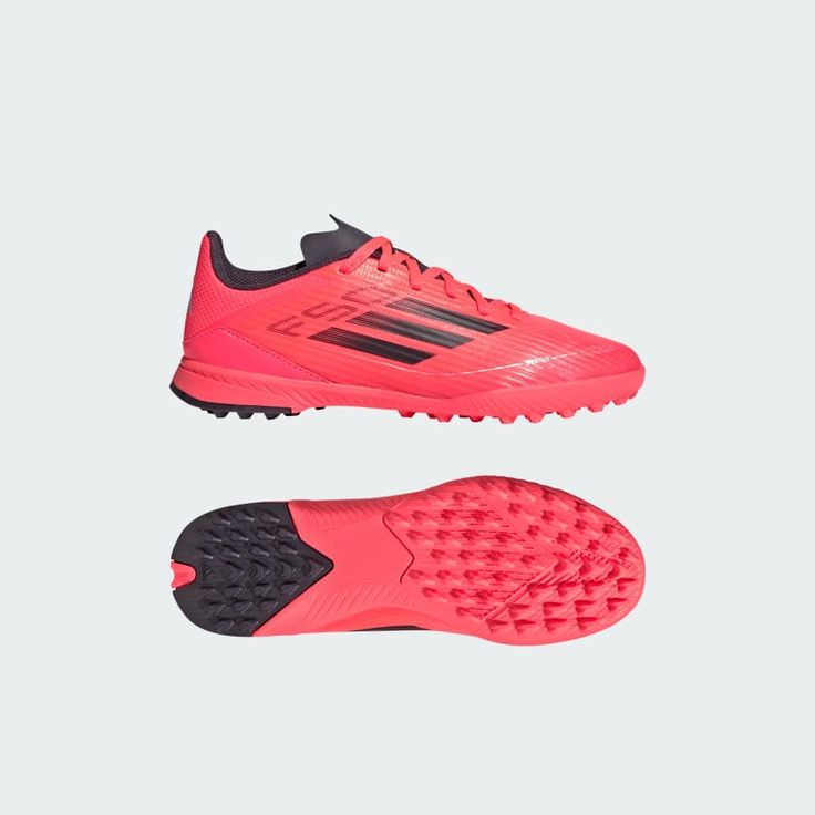 the adidas soccer shoe is shown in neon pink and black with an orange sole