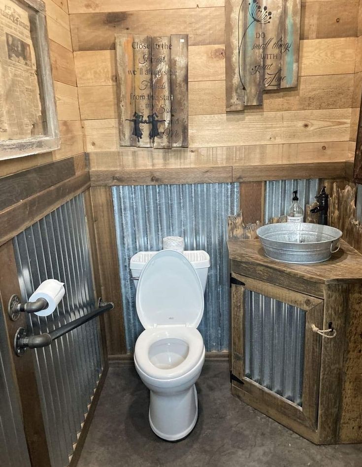 there is a toilet and sink in this rustic looking bathroom with wood paneling on the walls