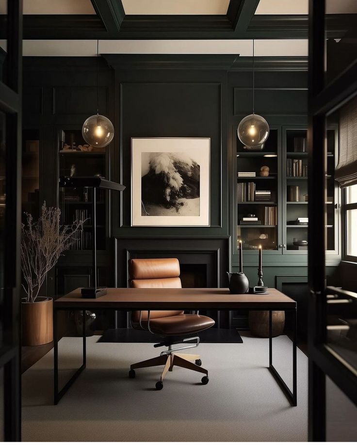 an office with dark green walls and leather chair in the foreground, framed by bookshelves