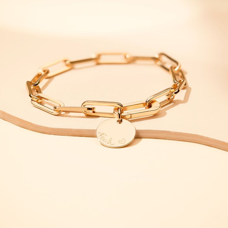 Forever linked by love. Featuring an iconic hinge to clip on your hand-engraved charms, this personalized link bracelet can be hand-engraved with your special words or messages.Available in 18K Champagne Gold PlatedCharm: 0.6 Diameter, 0.03 ThicknessChain length &amp; style: 7.3 Thick Trace ChainCharms are removable from this chain and can be worn with other Merci Maman charmsHand-engraved in our Paris workshopSent with love in a complimentary gift boxAny slight variations in lettering depth Luxury Gold Cable Chain Bracelet As Gift, Luxury Cable Chain Bracelet As Gift, Personalized Minimalist Chain Link Jewelry, Luxury Paperclip Chain Bracelet Gift, Luxury Paperclip Bracelet For Gifts, Personalized Gold Paperclip Bracelet, Luxury Paperclip Link Bracelet For Gift, Luxury White Gold Paperclip Bracelet As Gift, Luxury Paperclip Bracelet With Solid Link Construction