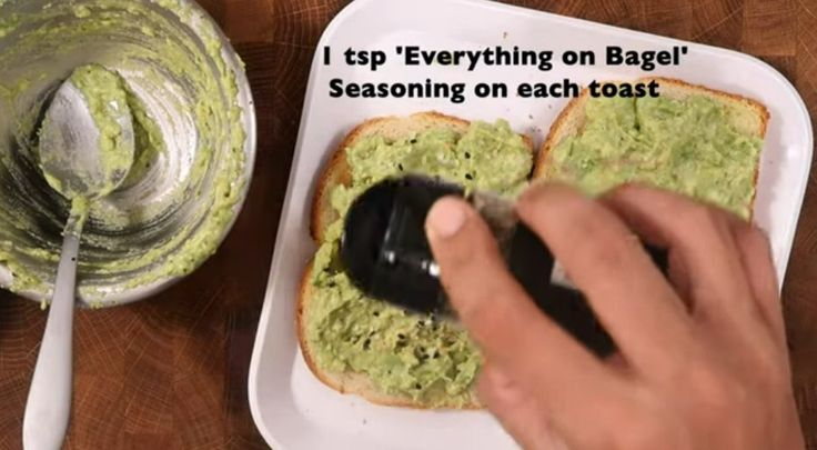 a person using a mouse on top of a piece of bread with guacamole