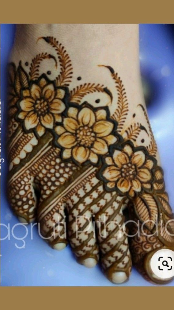 the hand is decorated with flowers on it