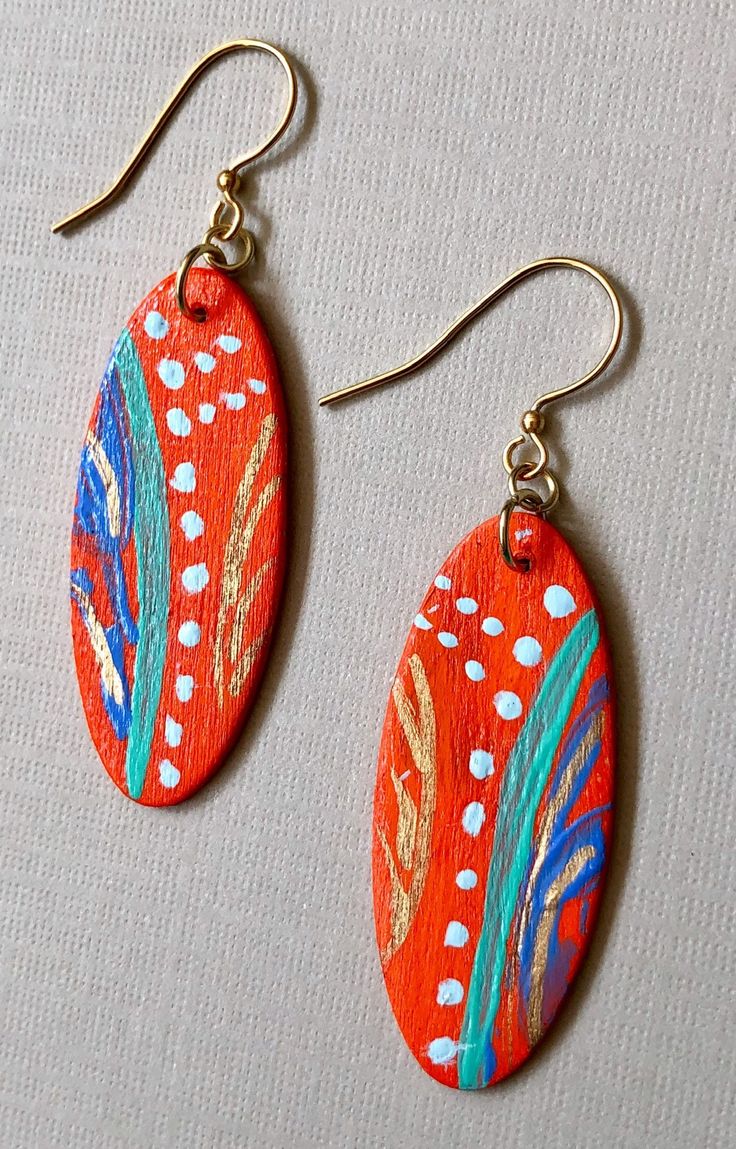 Made of weightless balsa wood, I have sanded and painted these with my original abstract design . Each pair I make is a one-of-a -kind. Bright orange hand-painted with abstract Nickel free gold tone ear wires. Total drop is 3". Finished with a water resistant coating.  Please do not immerse in water. Artistic Orange Earrings, Artsy Orange Drop Earrings, Artistic Orange Earrings With Ear Wire, Artistic Orange Drop Earrings, Artsy Orange Jewelry With Matching Earrings, Hand Painted Earrings Wood, Bracelets Easy, Aluminum Jewelry, Balsa Wood