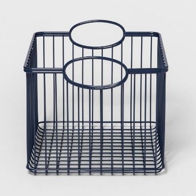 a blue wire basket with two circles on the top and bottom, sitting in front of a white background