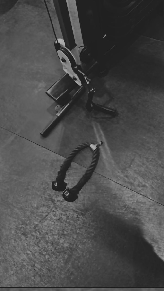 a black and white photo of a corded phone on the ground next to a door