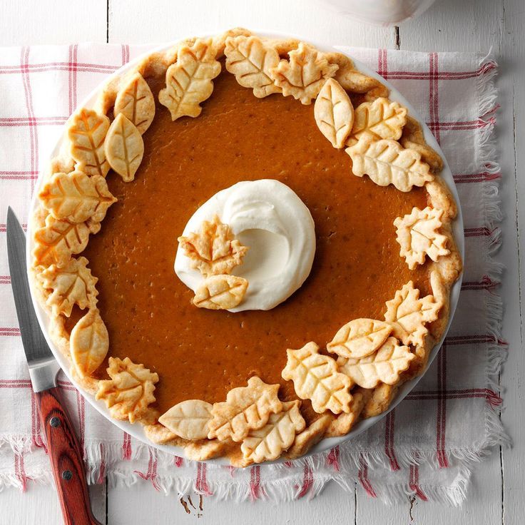 a pumpkin pie with whipped cream on top