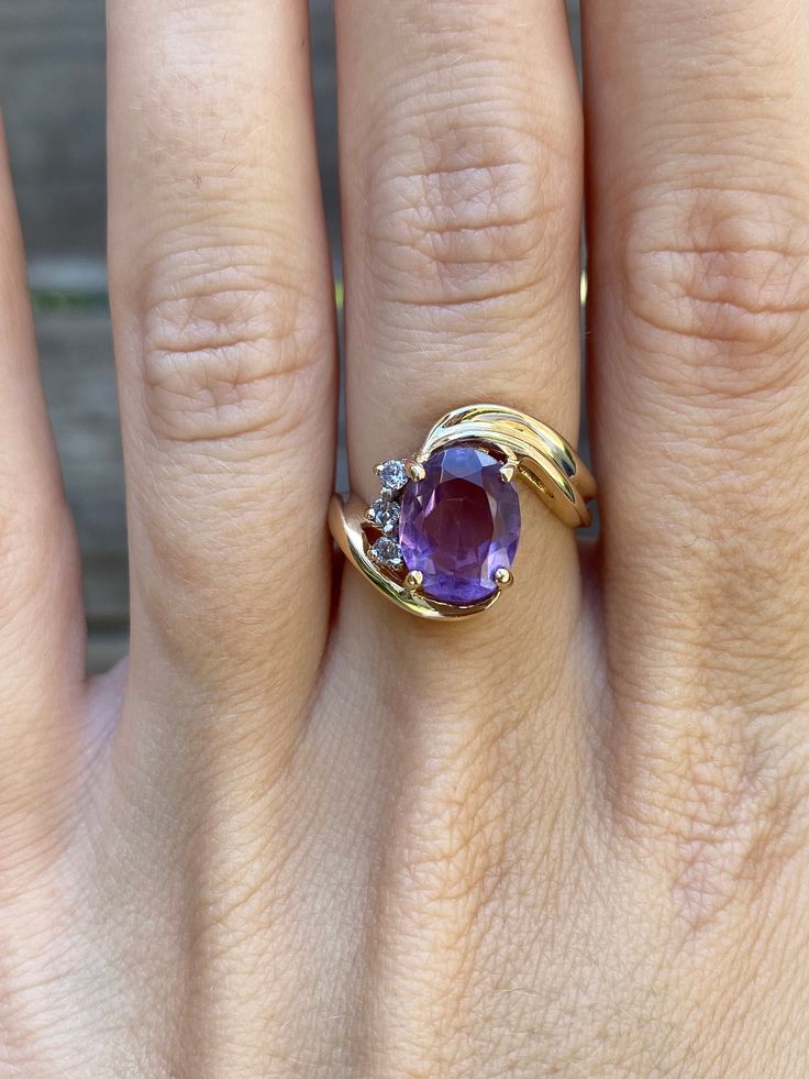 Total Weight: 5.1 grams Size: 6.75 Width: 2.6mm Amethyst: 10x7.8mm Diamonds: 1.5mm Condition: In great condition showing little wear with no damage. All gold has been thoroughly checked with an Olympus XRF spectrometer. It is guaranteed 14k gold.  All our jewelry is properly washed and disinfected to ensure customers get clean items with every order.  Returns accepted but may be subjected to a restock fee.  Please message with any questions:) Oval Amethyst Ring Stamped 14k, Formal Purple Amethyst Birthstone Ring, Purple Amethyst Birthstone Ring For Formal Occasions, Formal Purple Birthstone Gemstones, Classic Oval Purple Birthstone Ring, Oval Amethyst Birthstone Ring In Yellow Gold, Formal Purple Birthstone Ring With Prong Setting, Purple 14k Gold Jewelry For Anniversary, Oval Purple Diamond Gemstones