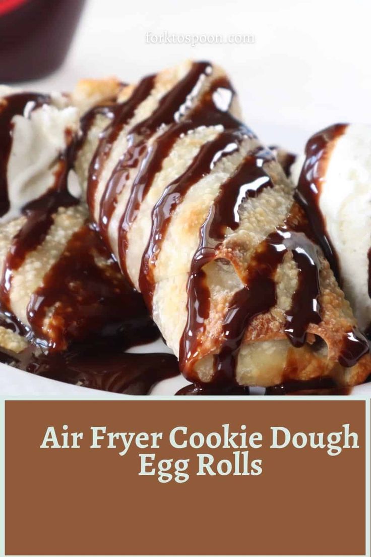 an air fryer cookie dough egg rolls on a plate with ice cream and chocolate drizzle