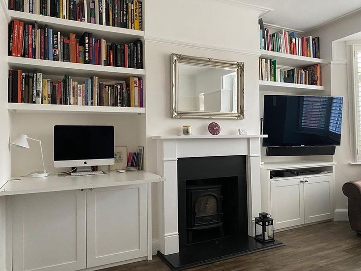 a living room filled with furniture and a fire place in front of a flat screen tv