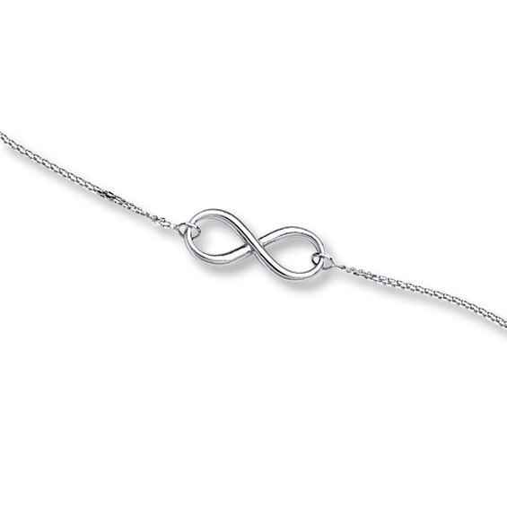 This elegant bracelet for her features an infinity symbol suspended between cable chains. Fashioned in 14K white gold, the bracelet adjusts from 7 to 7.5 inches in length, and secures with a lobster clasp. Sterling Silver Infinity Bracelet With Adjustable Chain, Sterling Silver Infinity Bracelets With Adjustable Chain, Bracelet For Her, Gold Stock, Jewelry Education, Jewelry Advice, Jared The Galleria Of Jewelry, Kay Jewelers, Infinity Symbol