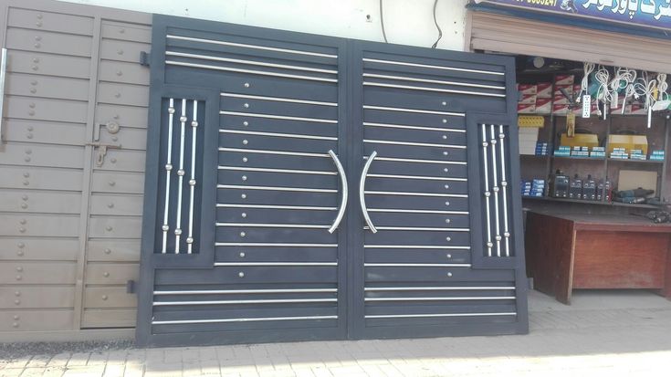 a store front with an open door and metal grills on the side of it