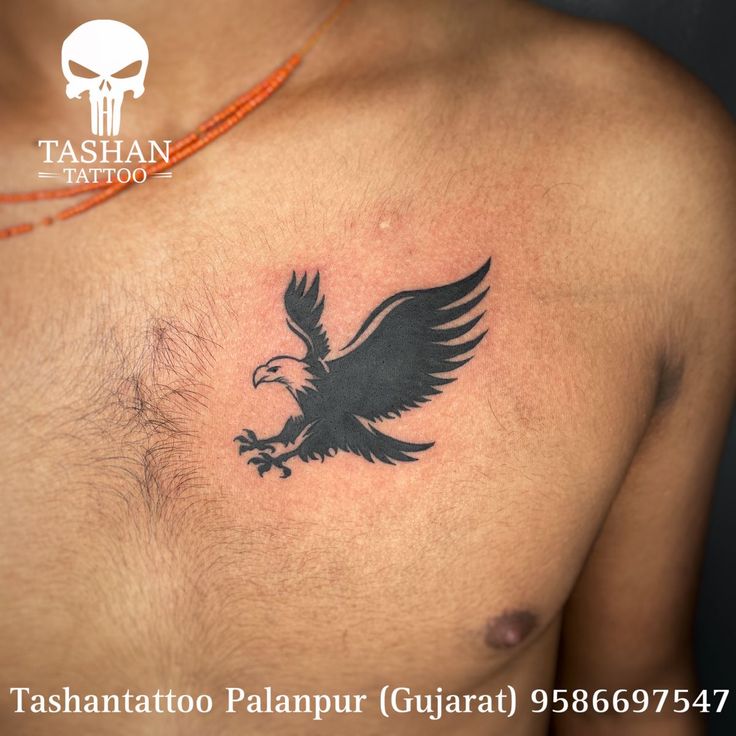 a tattoo on the chest of a man with an eagle in it's claws