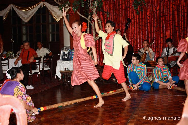 two children are dancing on the floor while others watch