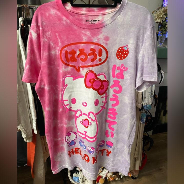 a hello kitty t - shirt hanging on a rack