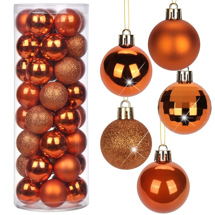 an assortment of orange and gold christmas ornaments