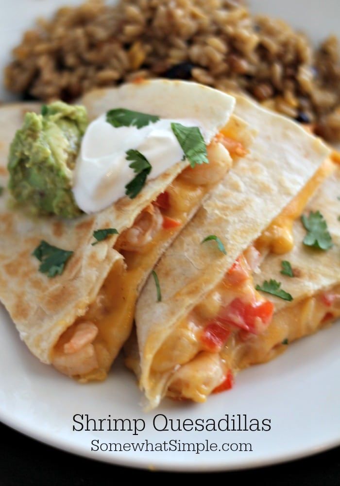 two quesadillas on a plate with rice and salsa