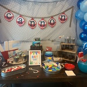 a table topped with lots of food and balloons