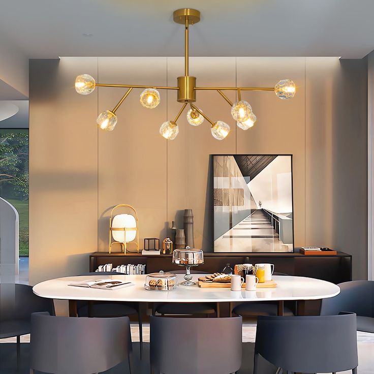 a dining room table with four chairs and a chandelier hanging from the ceiling