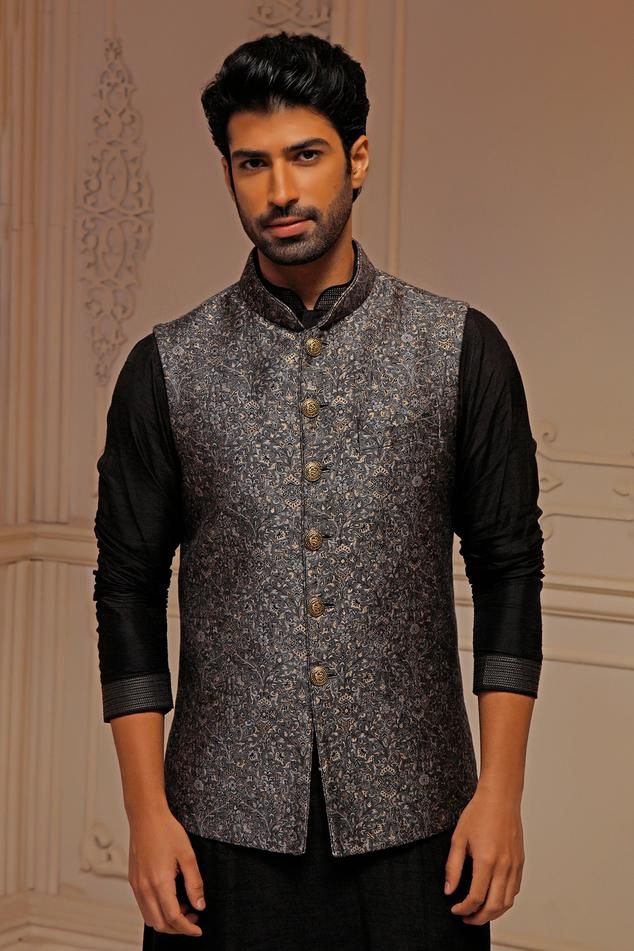 Grey sleeveless bundi in pashmina blend silk base with all over floral embroidery. Paired with long puffed sleeves kurta and a trouser.
Components: 3
Pattern: Floral
Neckline: Band Collar
Sleeve Type: Bundi: Sleeveless, Kurta: Long
Fabric: Silk
Color: Grey
Occasion: Sangeet, Wedding - Aza Fashions Designer Sleeveless Raw Silk Kurta, Elegant Sleeveless Designer Kurta, Traditional Sleeveless Kurta For Reception, Sleeveless Nehru Jacket With Resham Embroidery For Eid, Sleeveless Nehru Jacket With Zari Work For Transitional Season, Sleeveless Nehru Jacket With Zari Work, Designer Sleeveless Bandhgala With Zari Work, Designer Sleeveless Embroidered Nehru Jacket, Sleeveless Embroidered Nehru Jacket For Designer Wear