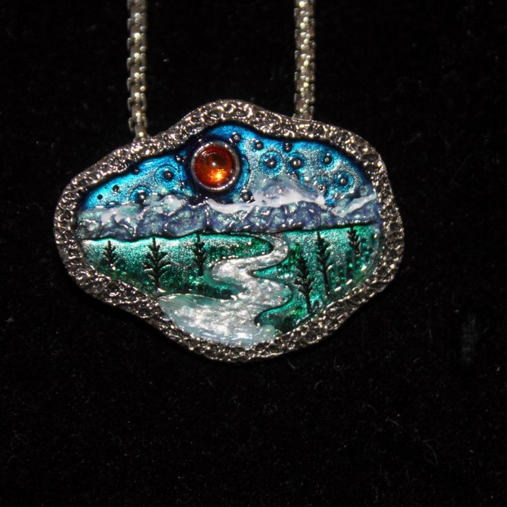 This Necklace Is Made From A Pewter Blank And Hand Enameled By Me. It Is A Bright Silver Nickel Free Pendant And Chain. The Pendant Is An Organic Shaped Oval With A Summer Landscape Stamped Into It. There Is An Amber Colored Round Crystal Sun In The Blue Sky. The Mountains Underneath Are Snow Capped And The Silver River Flows Out Onto The Green Plains With Trees. The Pendant Is 1 1/2" Wide By 1 1/8" Tall. The Chain Is A Box Type With A Lobster Claw Clasp. The Necklace Is 24" Long And Has A Lobst Hand Painted Silver Jewelry As Gift, Unique Hand Painted Silver Jewelry, Hand Painted Metal Jewelry Gift, Hand Painted Metal Jewelry As Gift, Hand Painted Metal Jewelry As A Gift, Hand Painted Silver Necklace For Gift, Nickel Free Enamel Pendant Necklace, Hand Painted Silver Enamel Jewelry, Silver Necklace With Black Enamel In Distinctive Style