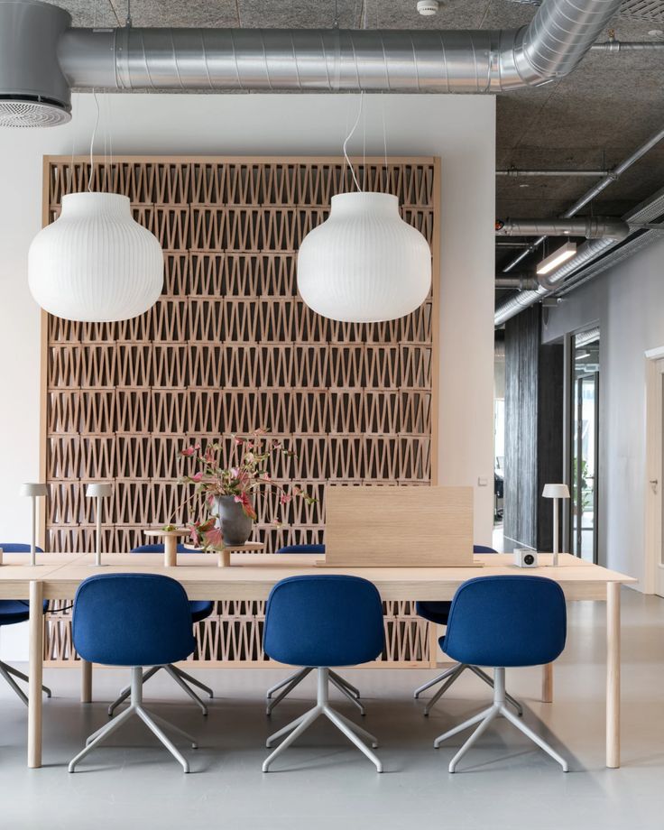 an office with blue chairs and wooden paneling