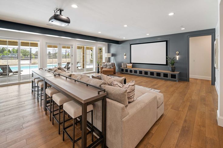 a living room filled with furniture and a flat screen tv mounted to the side of a wall