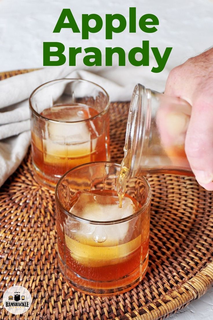 two glasses filled with liquid sitting on top of a wicker tray