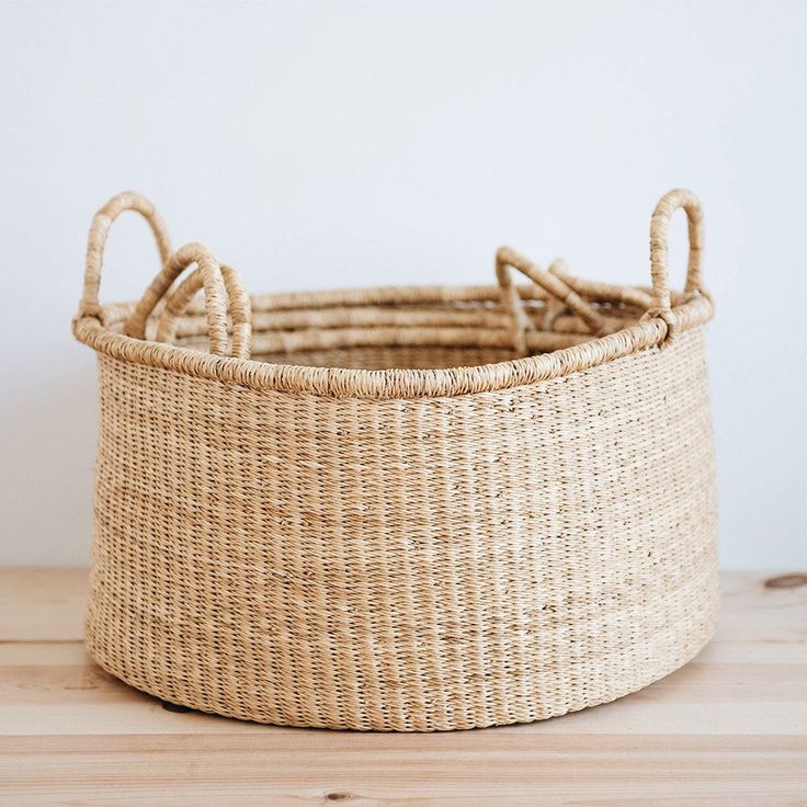 a woven basket sitting on top of a wooden table