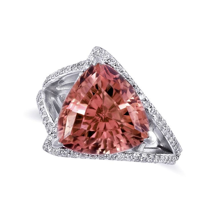 A trillion cut Pink Tourmaline, here is a gemstone that comes with a vivid color and an eye clean appearance. Tourmalines are known for their modern symbolism of love and with the feminine colors of this gem there will be no question about it. Set with diamonds in a 14K white gold band with a modern, handcrafted asymmetrical design, this piece will be a stunner. Feminine Colors, Physical And Chemical Properties, Pink Tourmaline Ring, Tourmaline Jewelry, Garnet Earrings, White Gold Diamond Rings, Rings Rings, Tourmaline Ring, White Gold Band