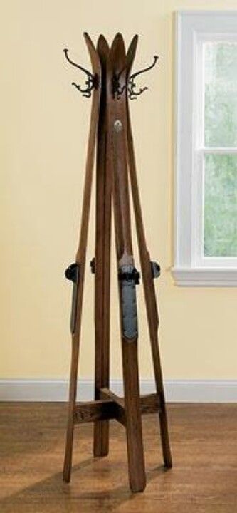 a pair of skis are on a stand in front of a window