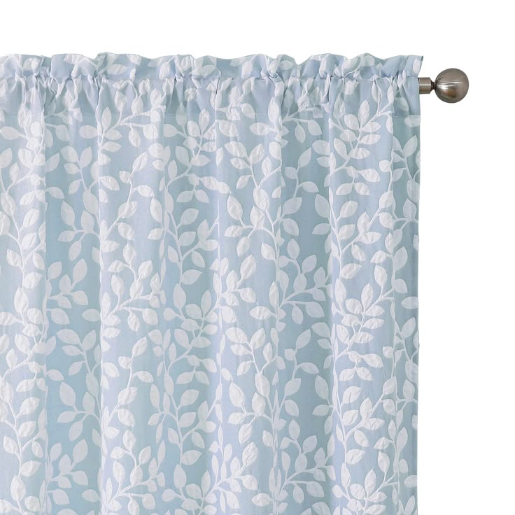 a blue and white curtain with leaves on it