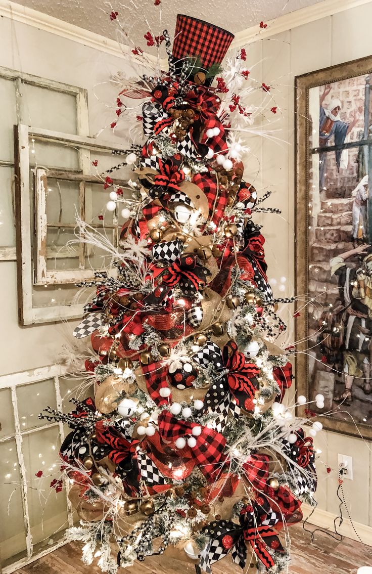 a christmas tree decorated with red and black bows