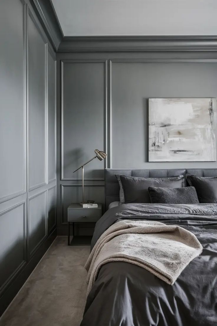 a bedroom with gray walls and grey bedding