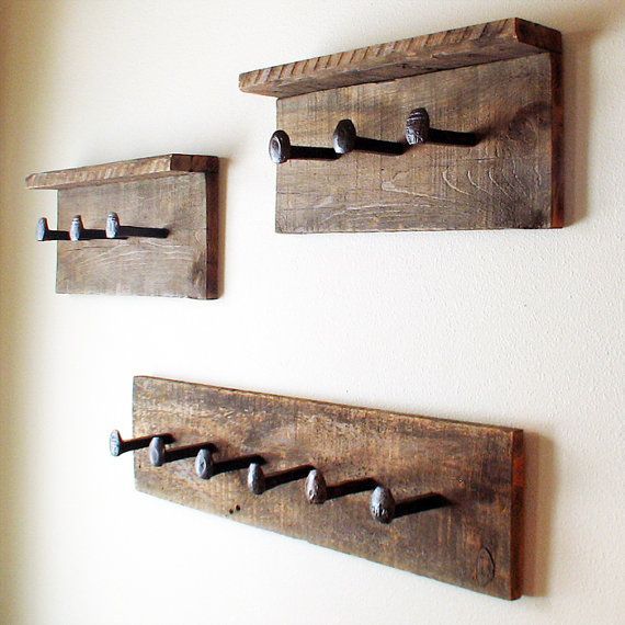 three wooden hooks are hanging on the wall