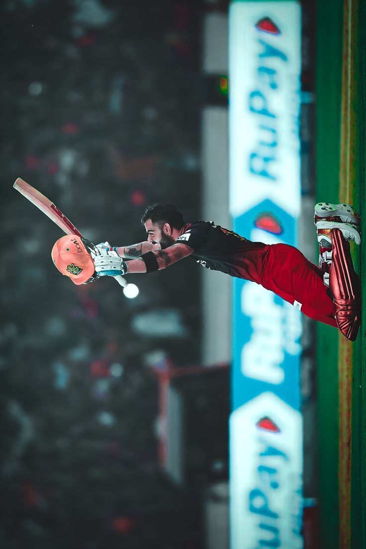 a man on a skateboard in the air with his arms out and feet up