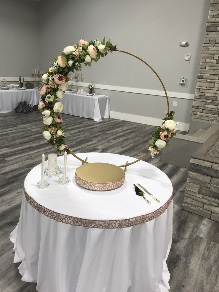 a table with a cake and flowers on it