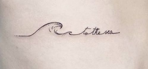 a tattoo with the word atta written in cursive writing on it's side