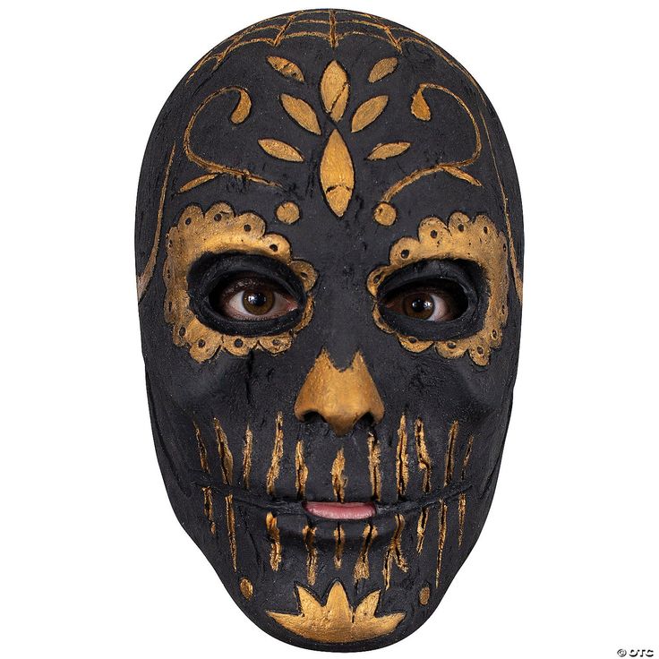 a black mask with gold designs on it