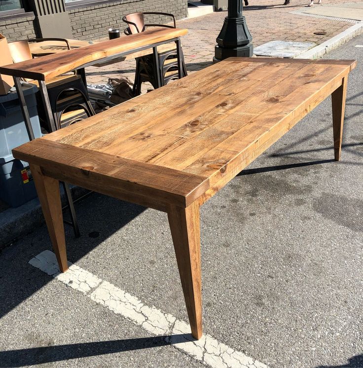 a wooden table sitting on top of a parking lot