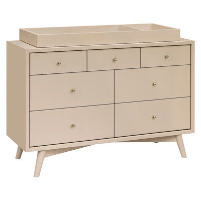 a white dresser with six drawers and two baby changing tables