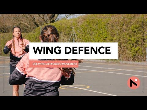 two women are playing basketball on an outdoor court with the words wing defence above them