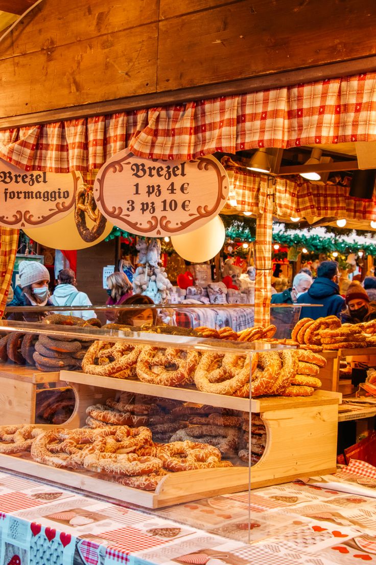 a bakery with lots of different types of doughnuts and pastries on display