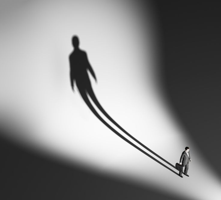 two people standing in the shadow of a man on a long thin line between them