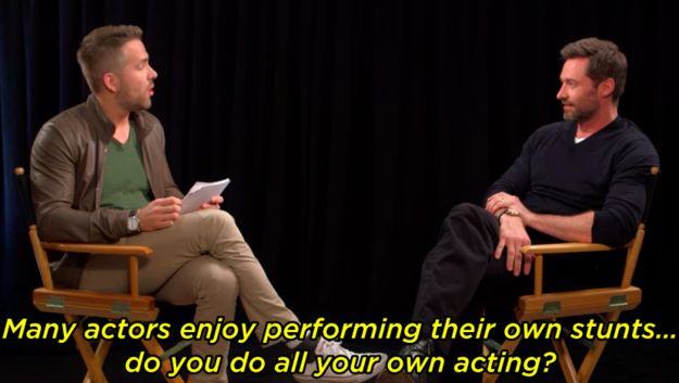 two men sitting in chairs talking to each other on the set of a movie with black curtains behind them