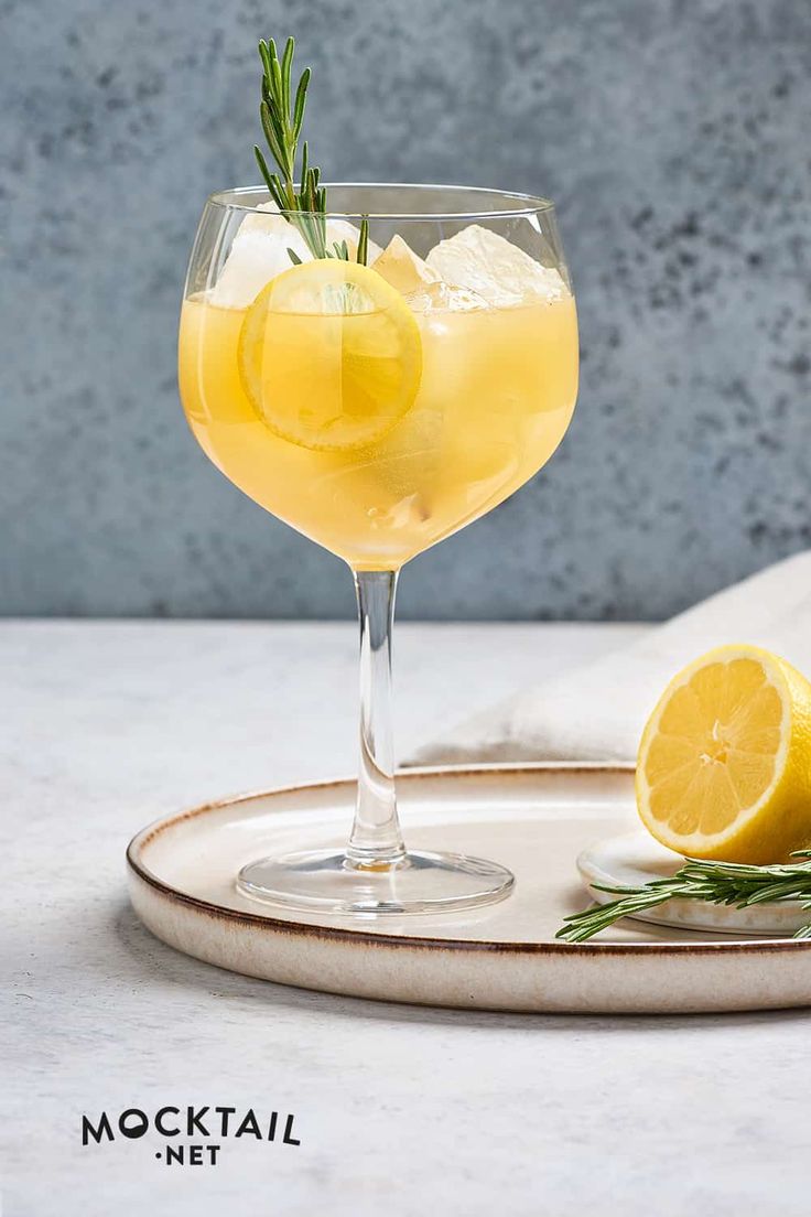 a glass filled with lemonade sitting on top of a plate