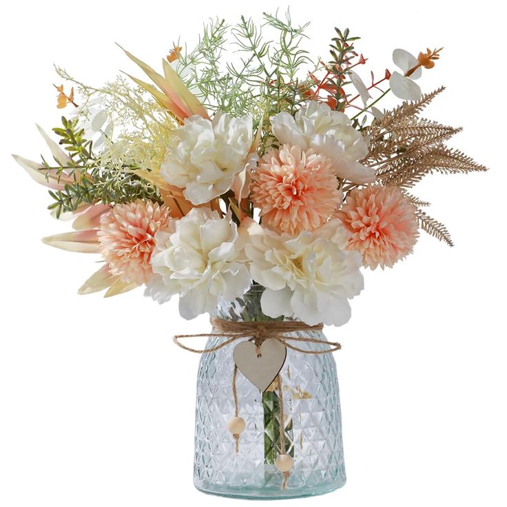 a vase filled with lots of flowers on top of a table