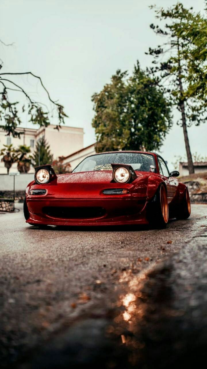 a red sports car is parked on the street