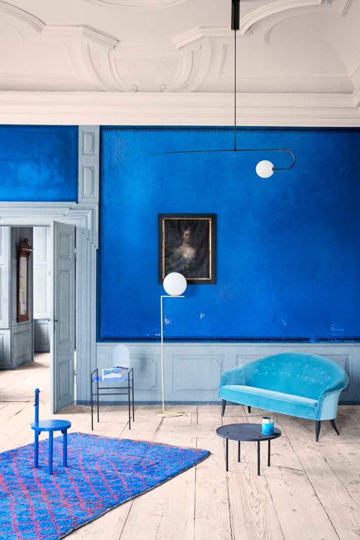 a living room with blue walls and furniture